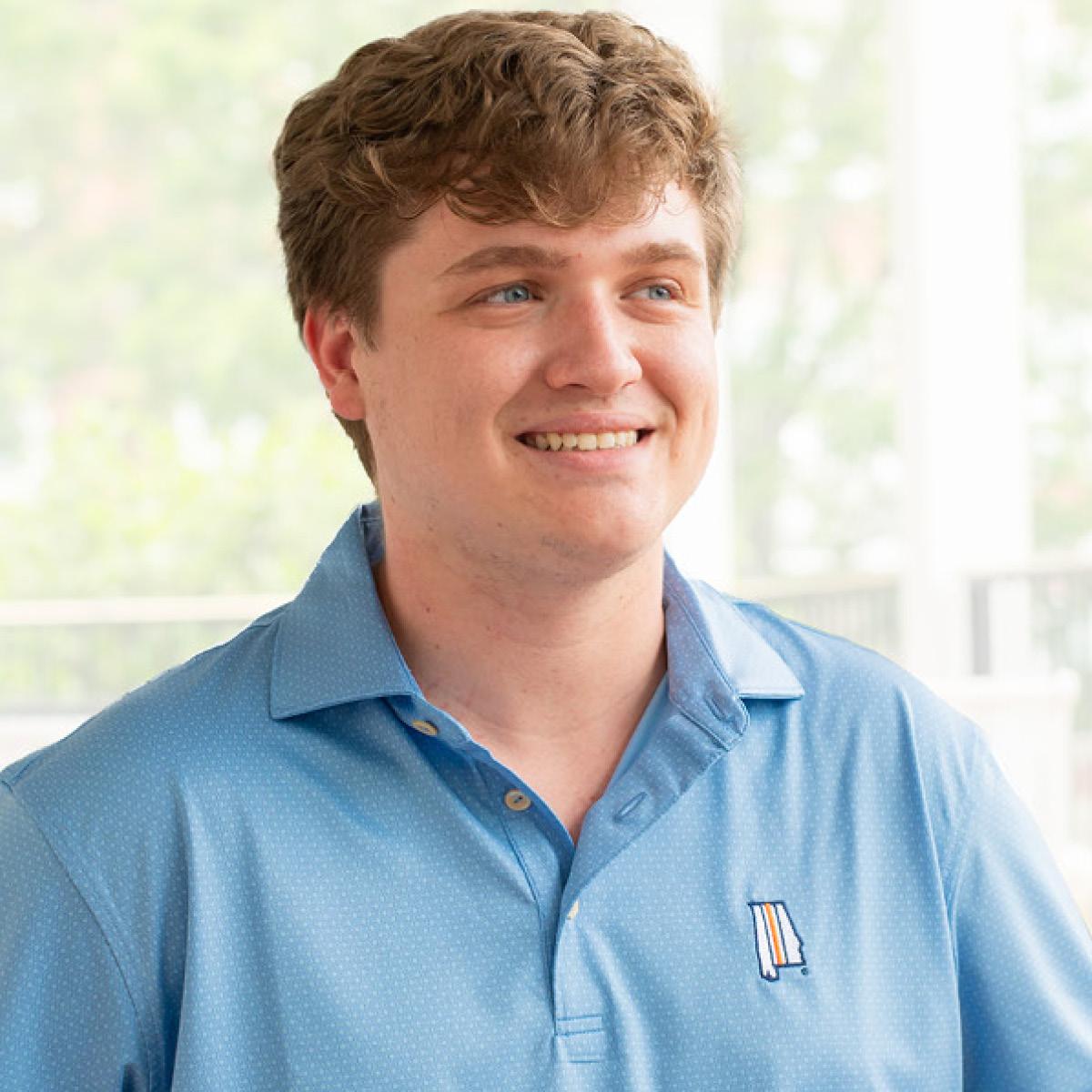 Auburn student wearing an Auburn light blue polo